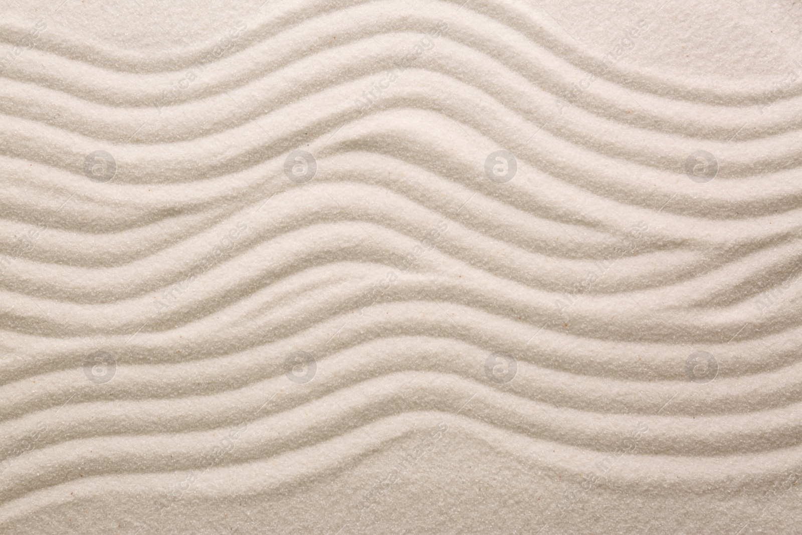 Photo of White sand with pattern as background, top view. Concept of zen and harmony