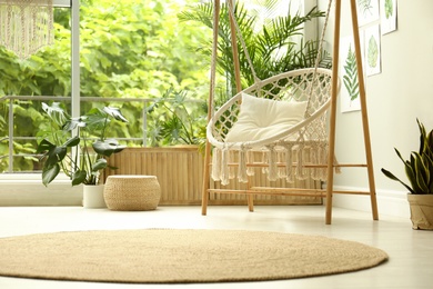 Comfortable hammock chair in stylish room. Home interior