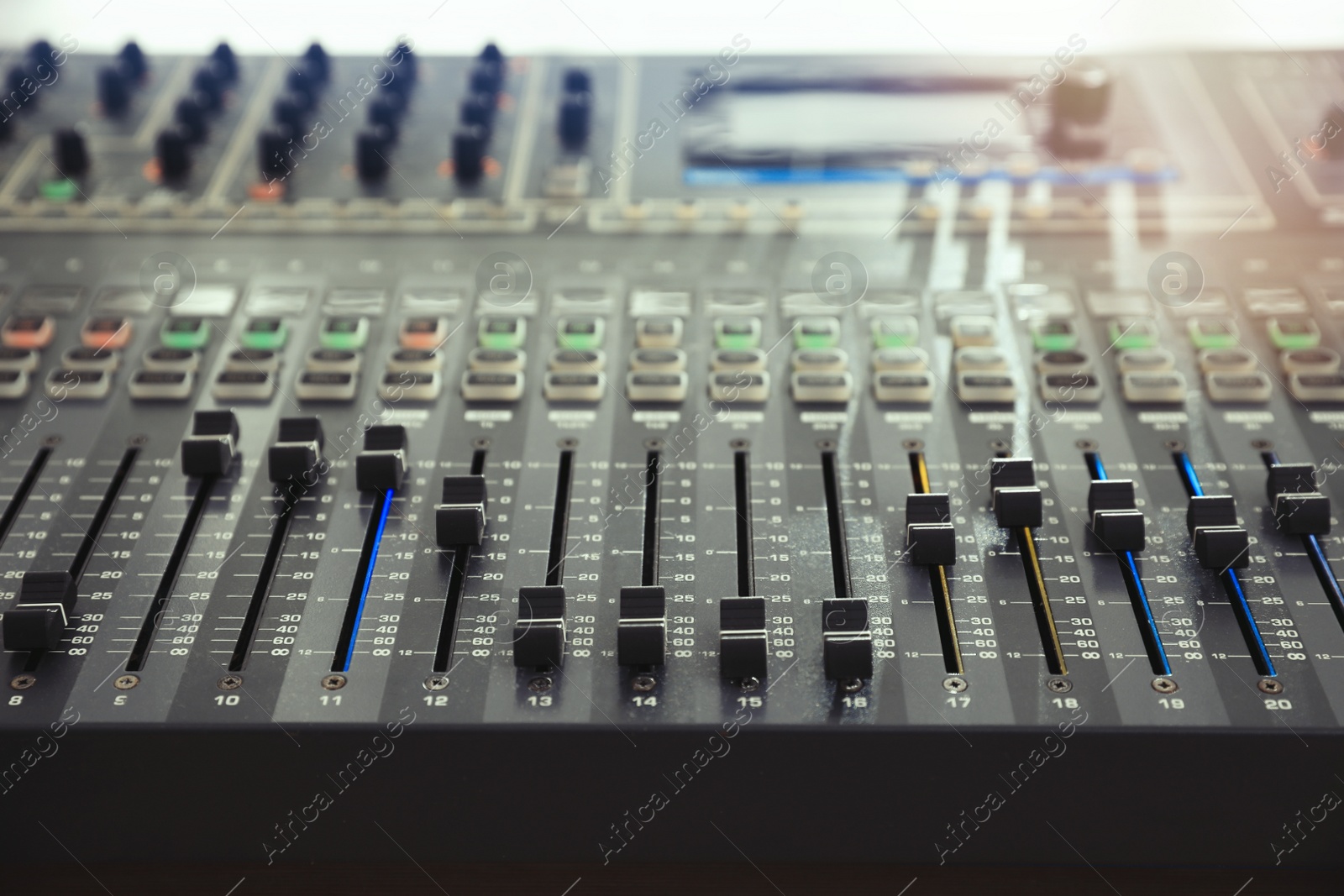 Photo of Professional mixing console on table in modern radio studio, closeup
