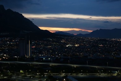 Picturesque view of sunset over city and mountains