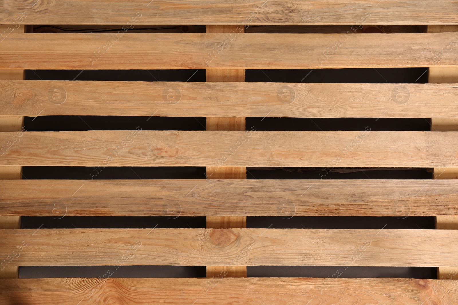 Photo of Wooden pallet as background, top view. Transportation and storage