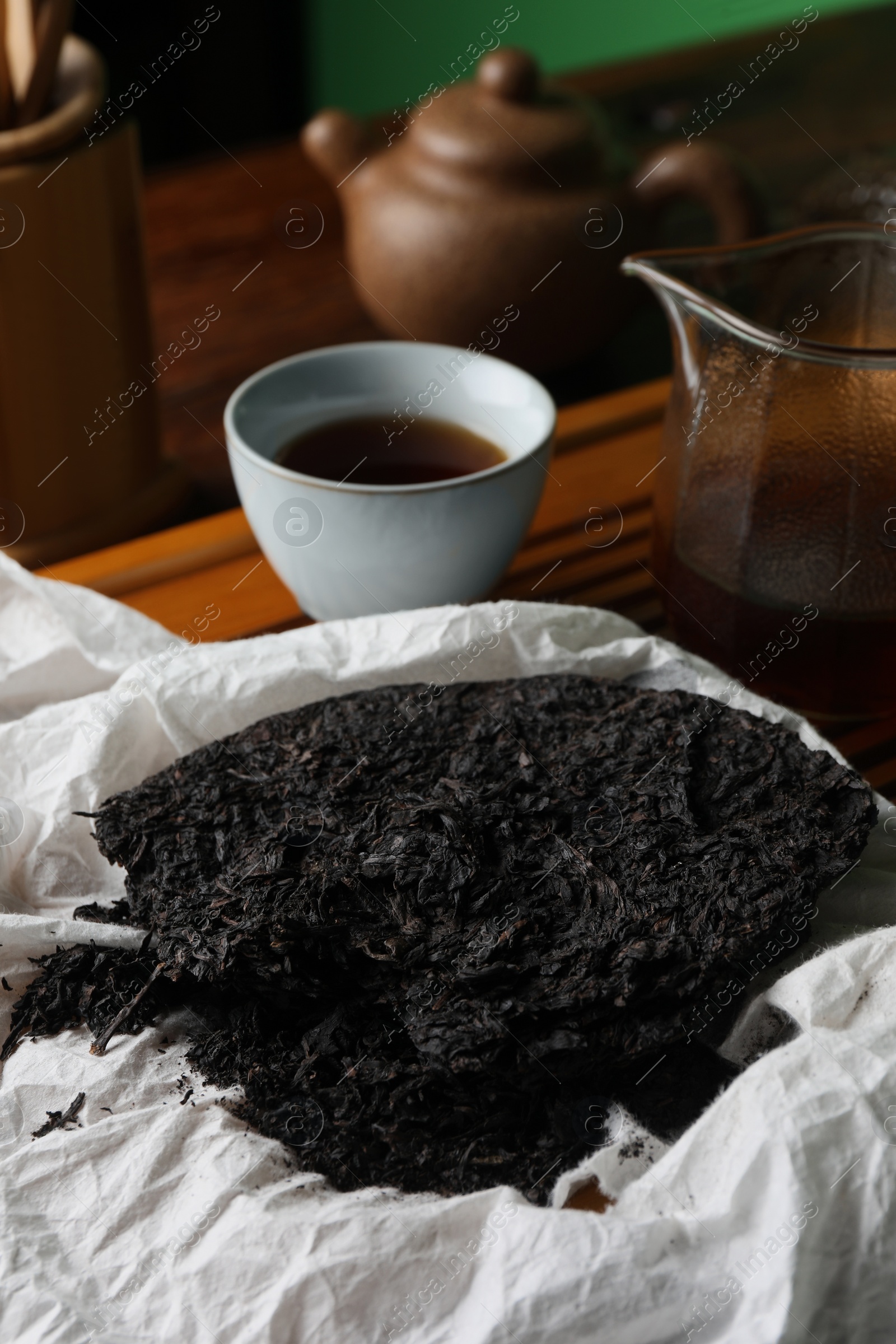 Photo of Broken disc shaped pu-erh tea on table