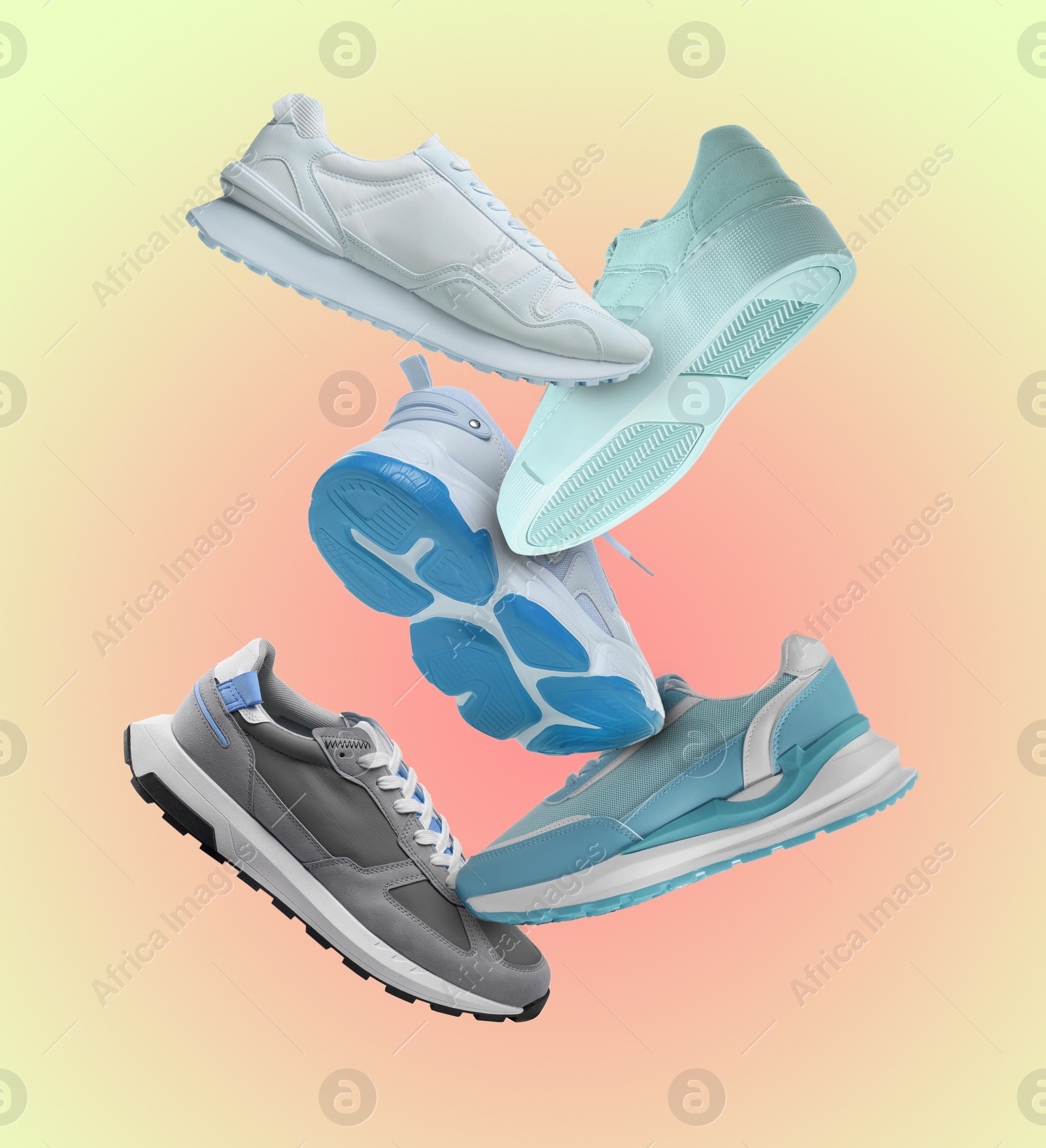 Image of Different sneakers falling on beige gradient background