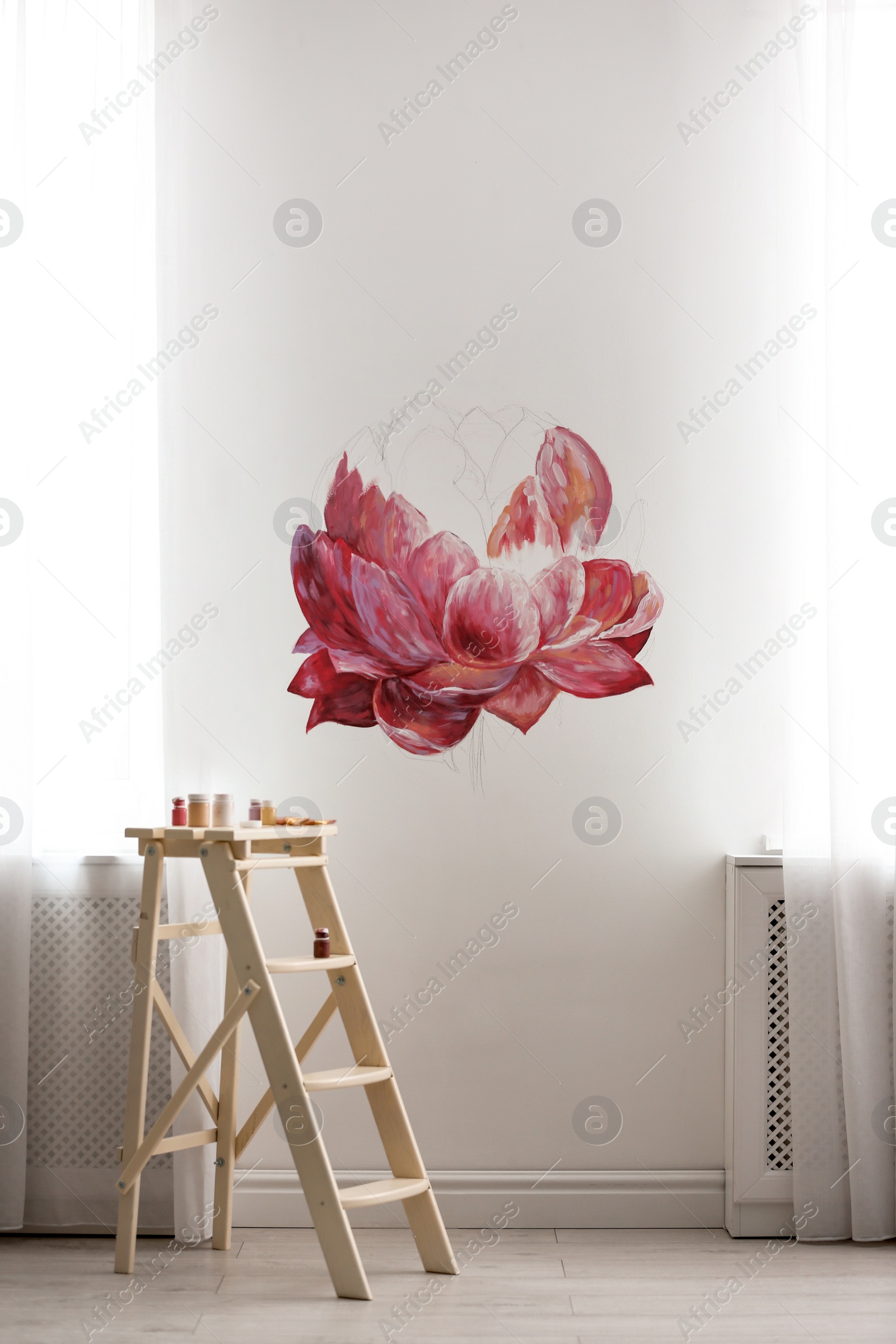 Photo of Unfinished flower painting on white wall in room. Interior design
