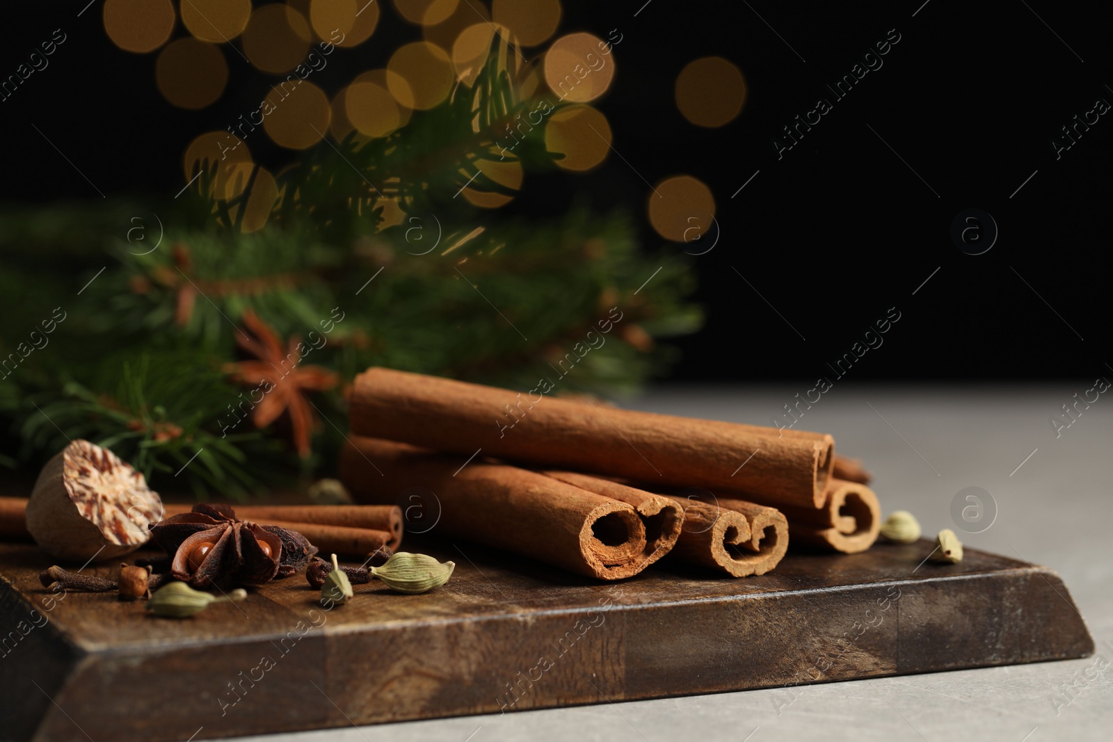 Photo of Board with different aromatic spices on table, closeup