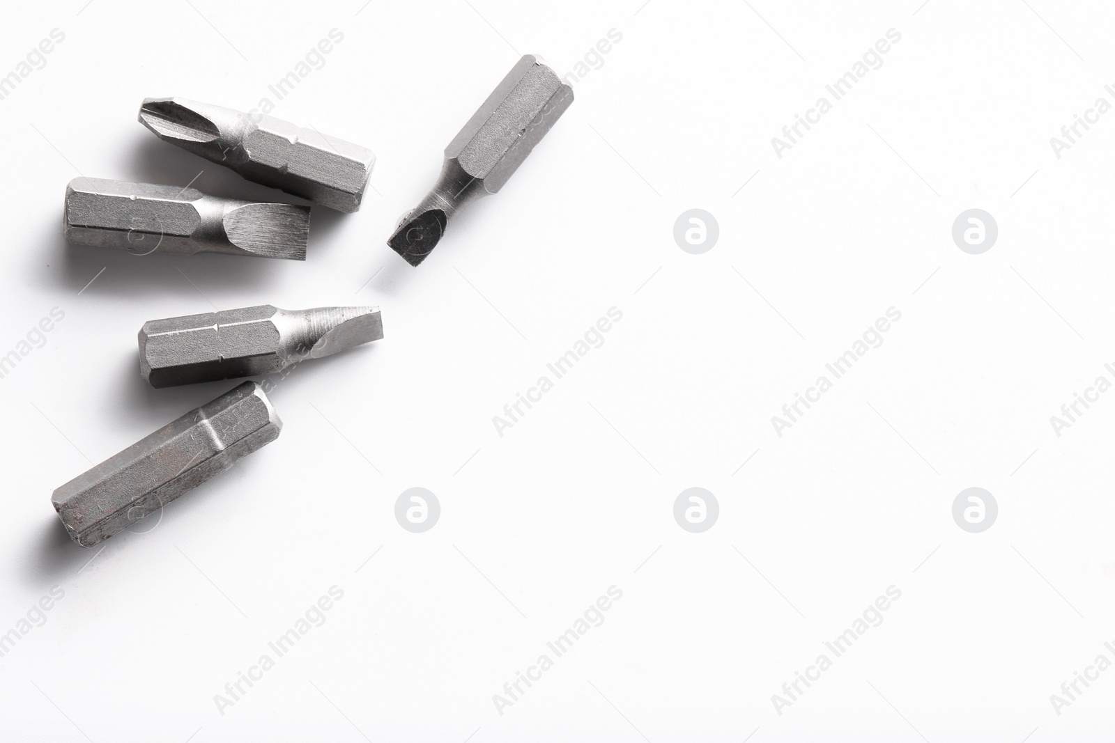 Photo of Different screwdriver bits on white background, top view