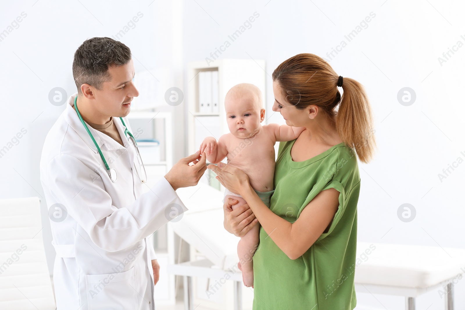 Photo of Woman with her baby visiting children's doctor in hospital