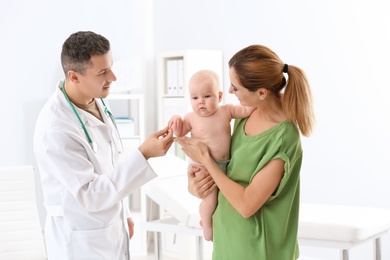 Woman with her baby visiting children's doctor in hospital