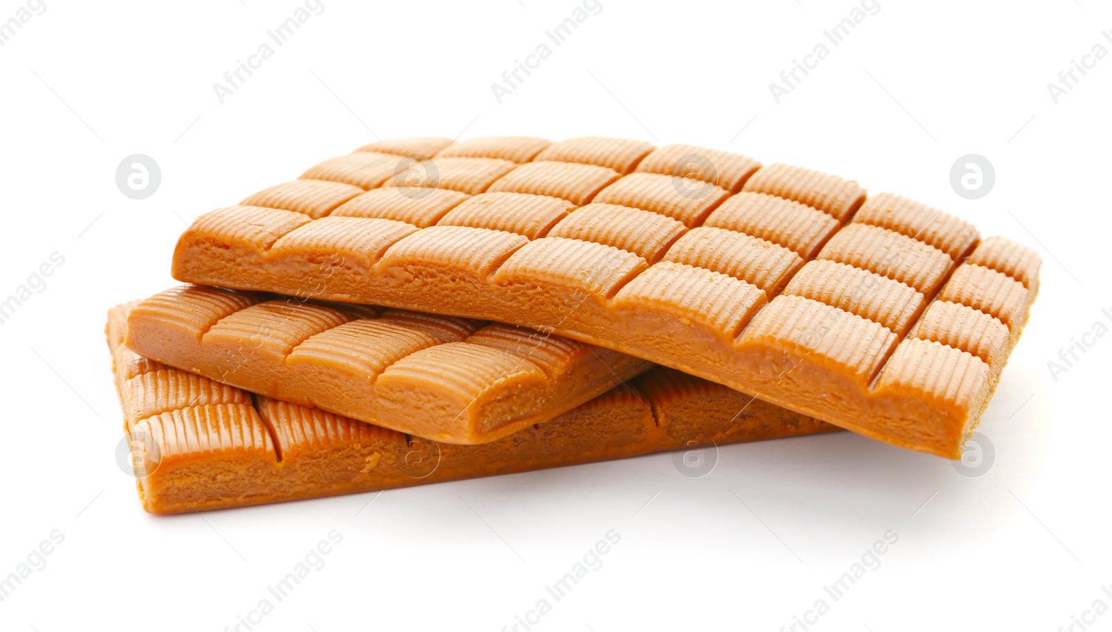 Photo of Delicious caramel candies on white background