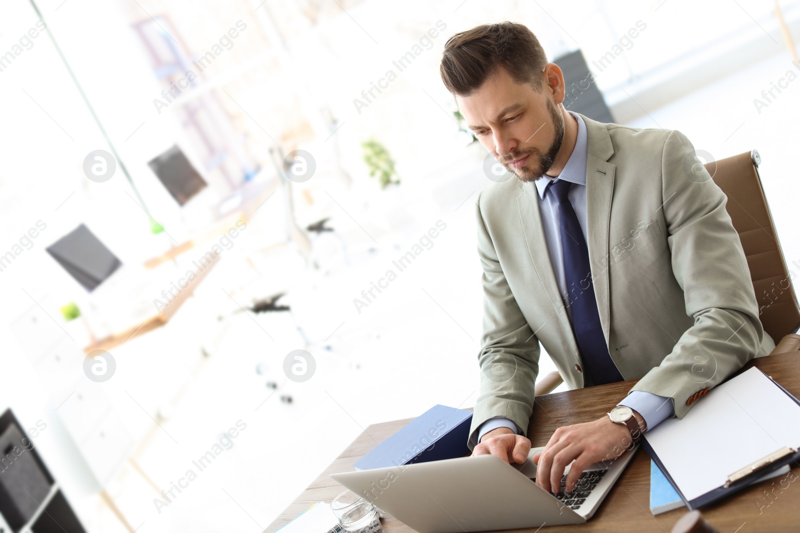 Photo of Male lawyer working with laptop in office