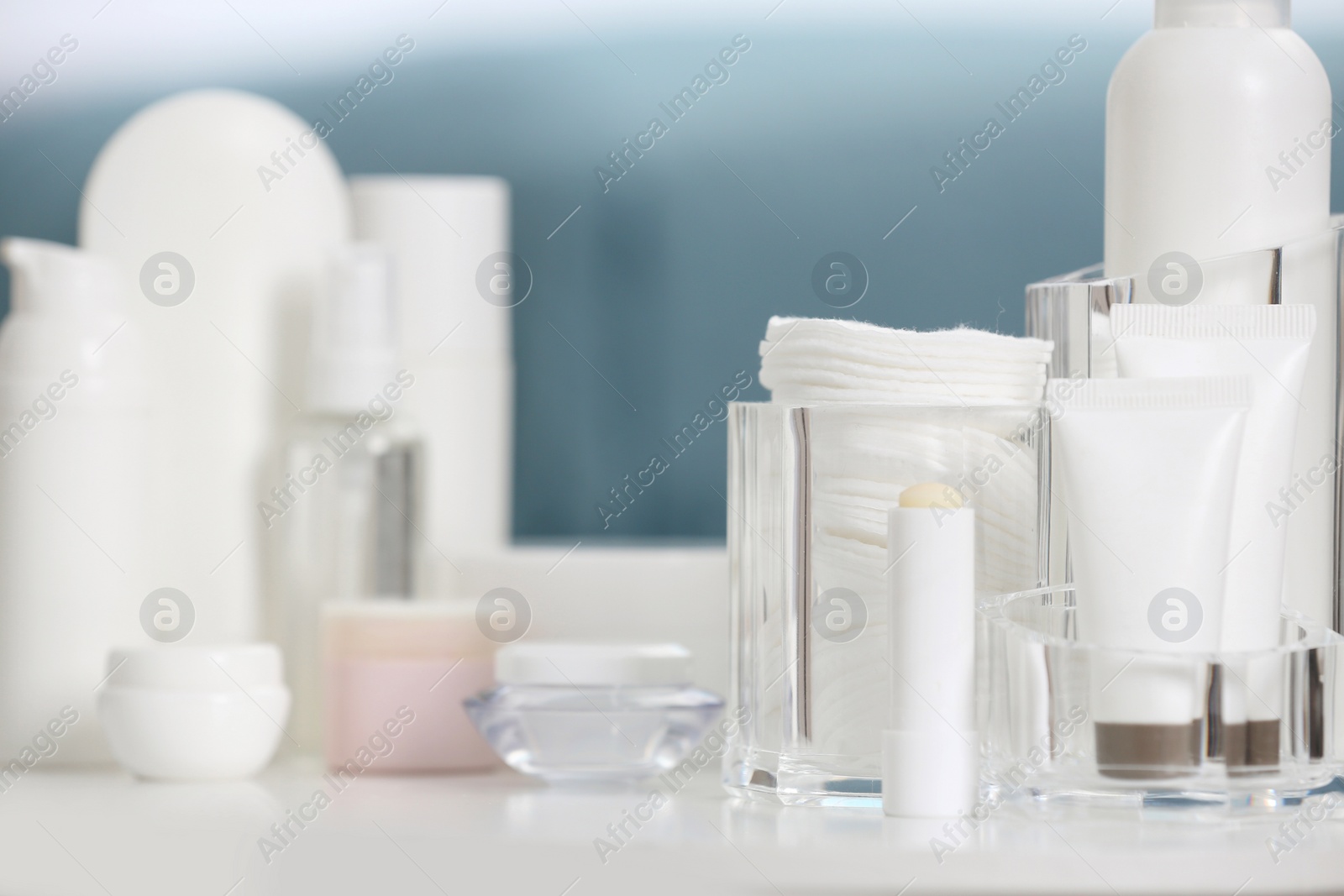 Photo of Set of cosmetic products on table against blurred background. Space for text