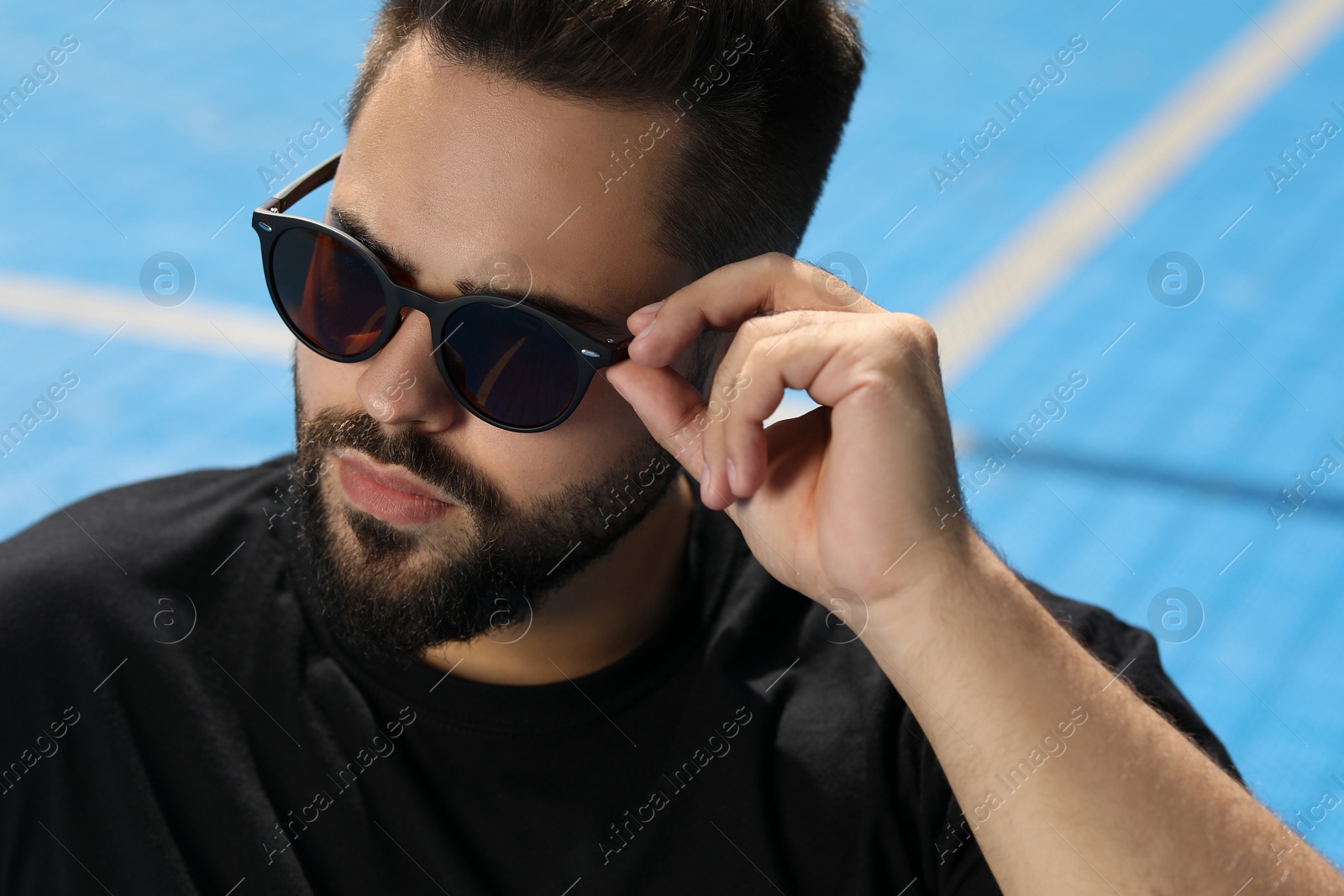 Photo of Handsome man in sunglasses outdoors, space for text