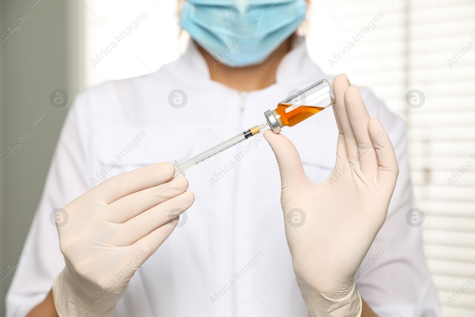 Photo of Doctor with vial and syringe in hospital, closeup. Vaccination day