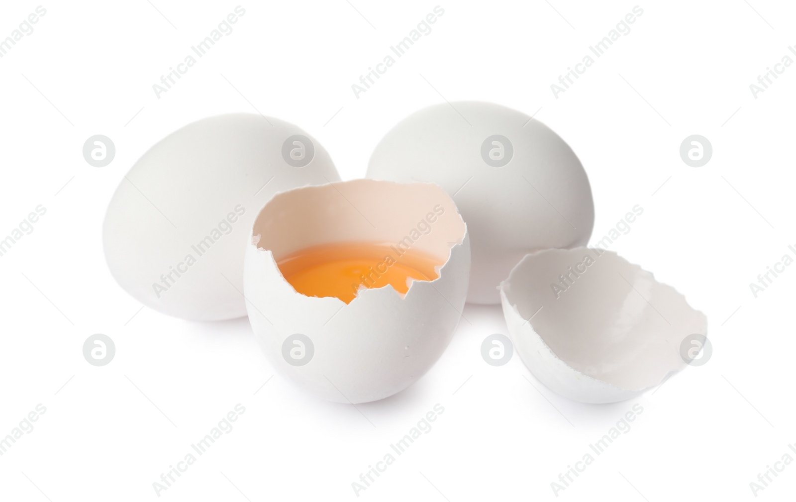 Photo of Cracked and whole chicken eggs on white background