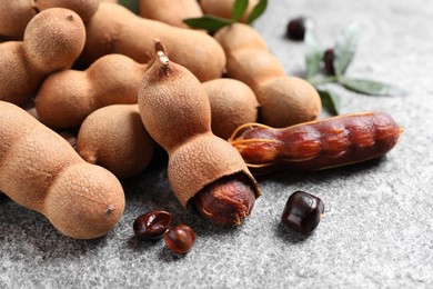 Delicious ripe tamarinds on grey table, closeup