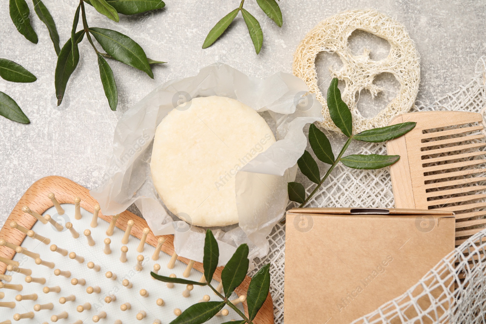 Photo of Flat lay composition with solid shampoo bar on light grey table