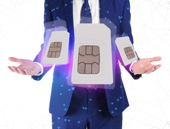 Man demonstrating SIM cards of different sizes on white  background, closeup 