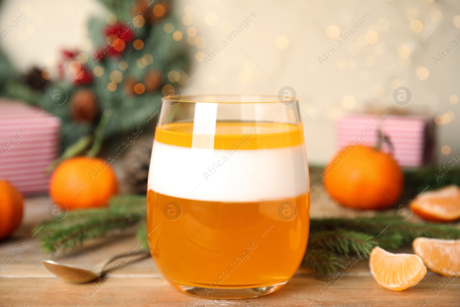 Photo of Delicious tangerine jelly in glass on wooden table, closeup