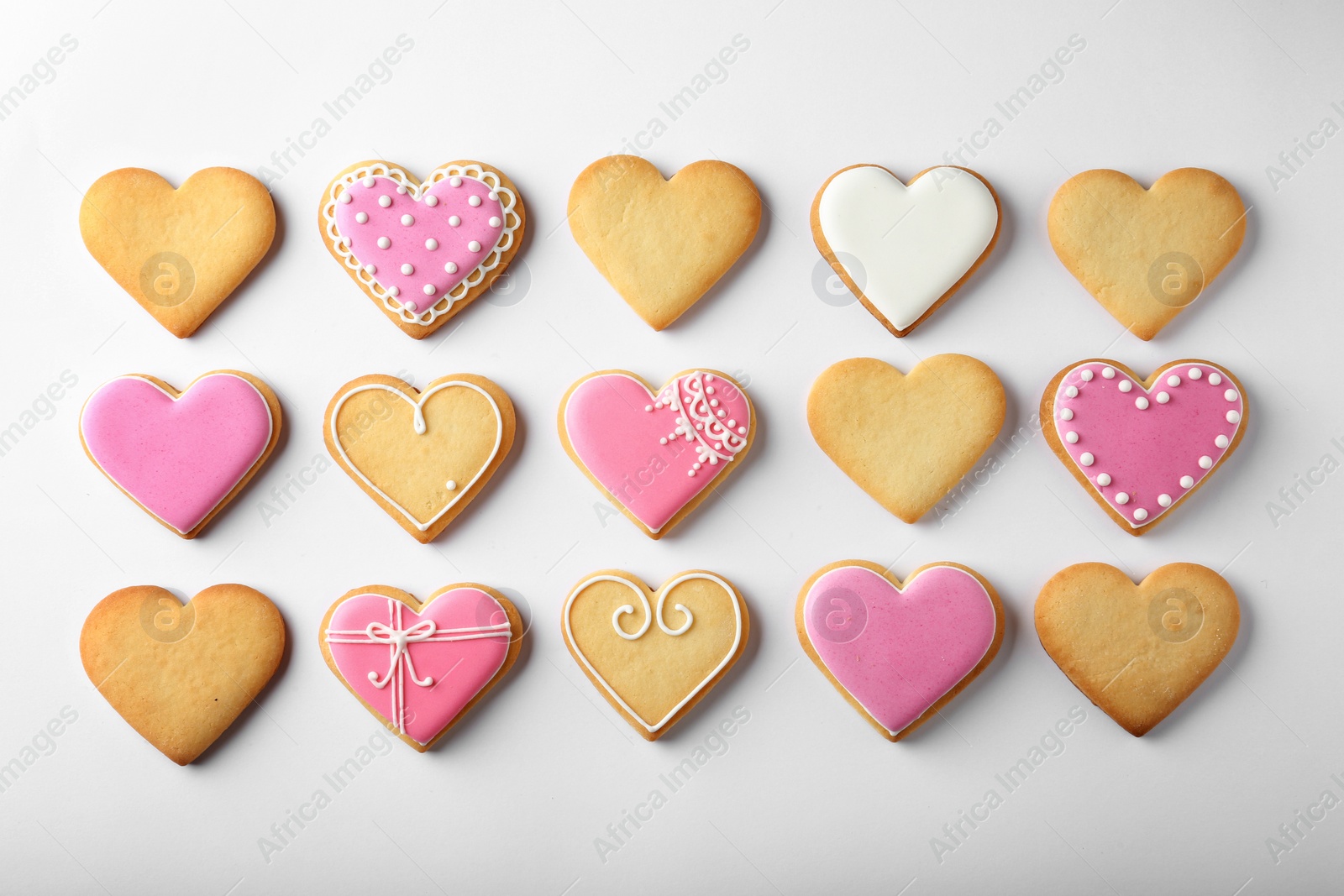 Photo of Decorated heart shaped cookies on white background, top view