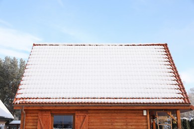 Photo of House roof covered with snow outdoors, closeup
