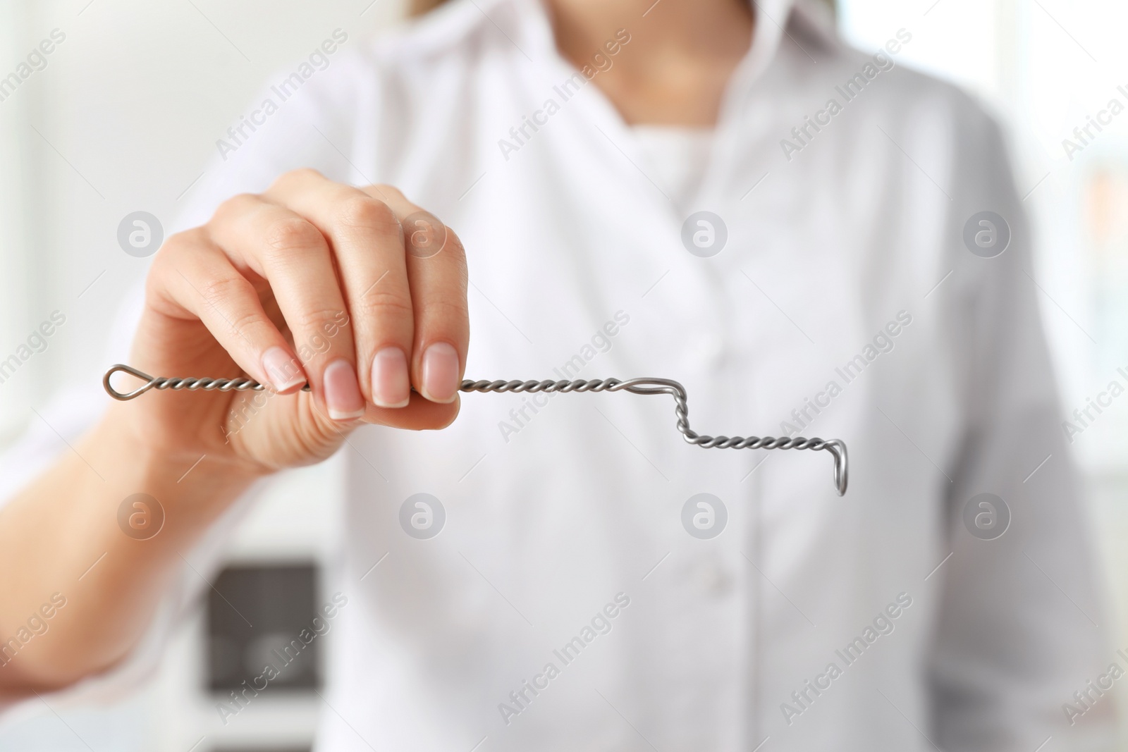 Photo of Speech therapist with logopedic probe in clinic, closeup