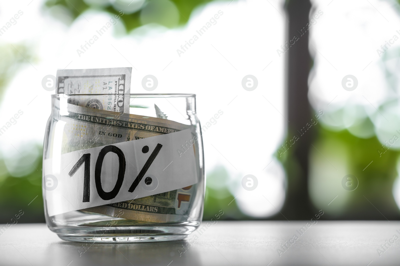 Photo of 10 PERCENT written on paper and money in jar against blurred background, space for text