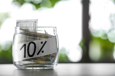 10 PERCENT written on paper and money in jar against blurred background, space for text