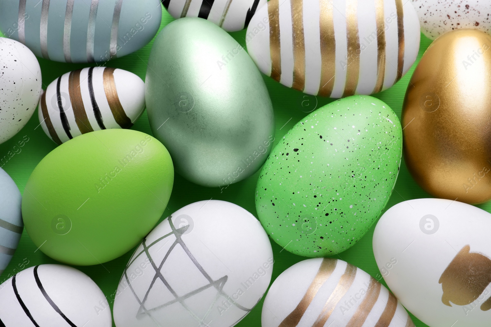 Photo of Beautifully painted Easter eggs as background, top view