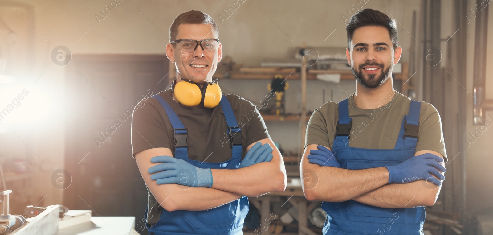 Image of Professional male carpenters in workshop. Banner design