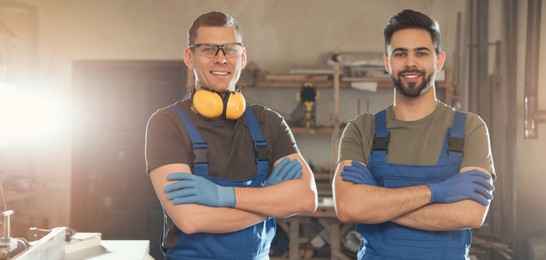 Image of Professional male carpenters in workshop. Banner design