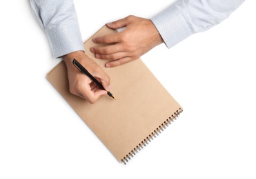 Photo of Man with pen and notepad on white background, top view. Closeup of hands