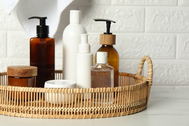 Bath accessories. Personal care products on white table near brick wall