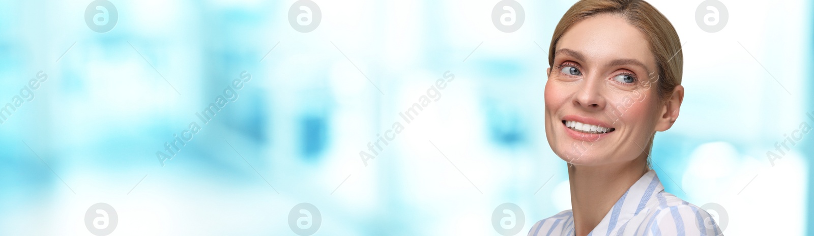 Image of Woman with clean teeth smiling on blurred background, space for text. Banner design