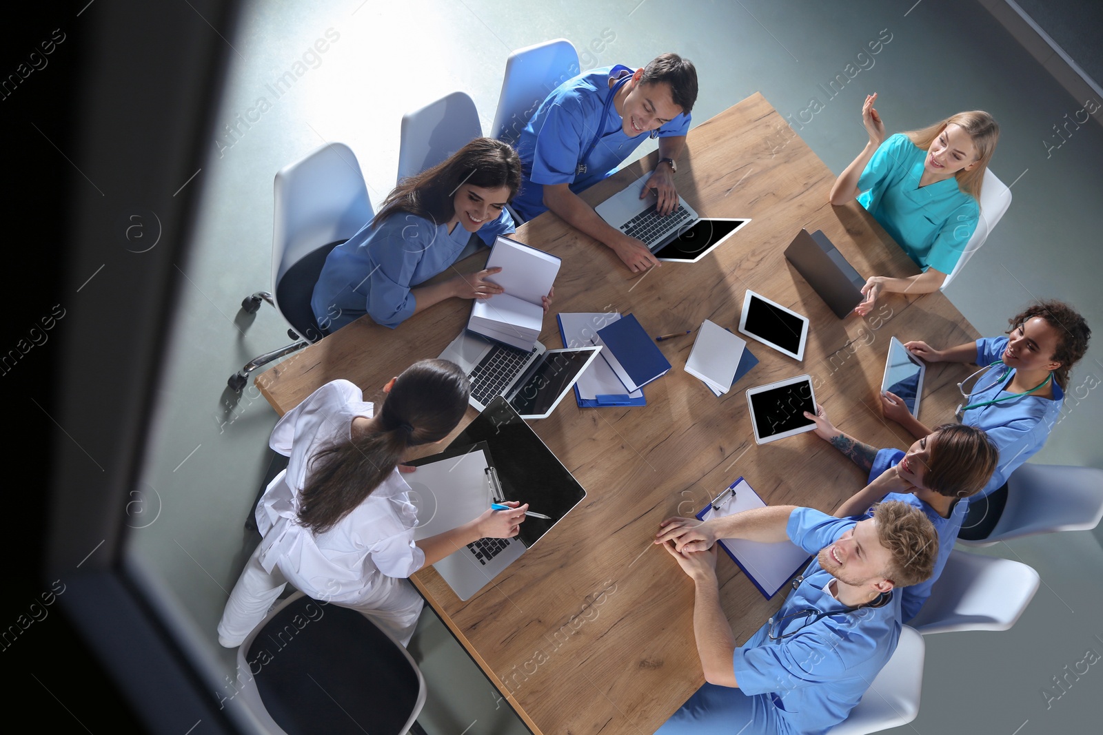 Photo of Group of medical students with gadgets in college, top view