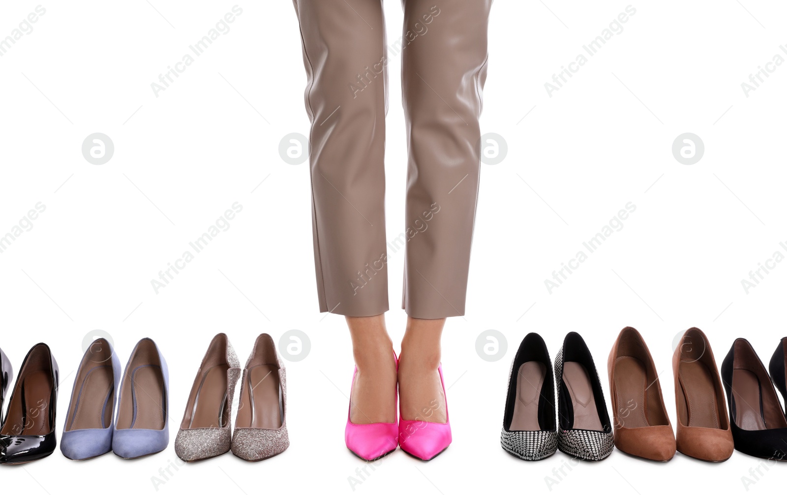 Photo of Fashionable woman with many different high heel shoes on white background, closeup