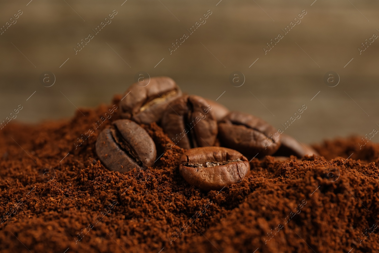 Photo of Pile of ground coffee with roasted beans, closeup