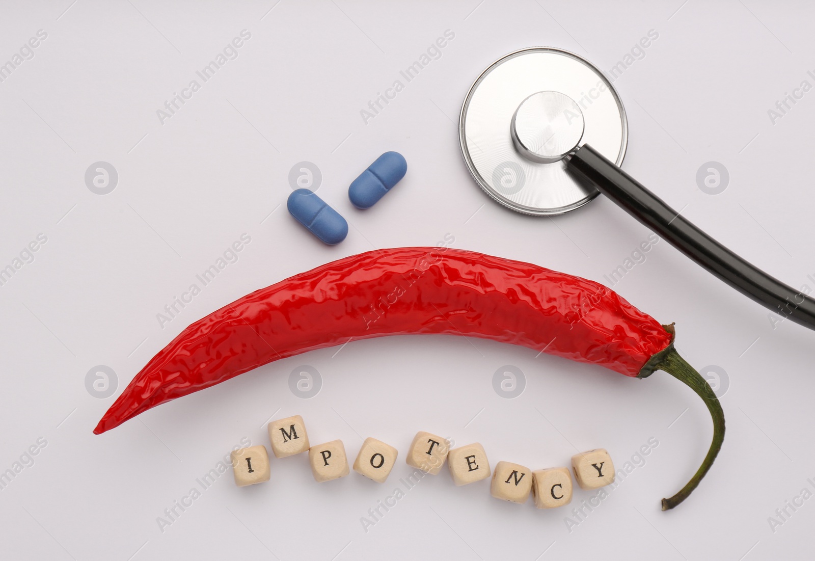 Photo of Flat lay composition of chili pepper and cubes with word Impotency on white background