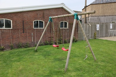 Spacious backyard with swing set on spring day