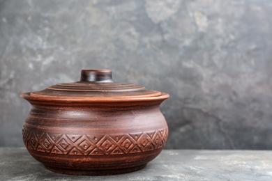 Photo of Clay pot on grey table, space for text. Handmade utensil