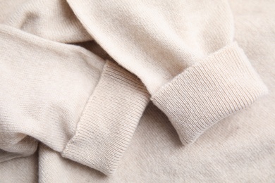 Photo of Warm cashmere sweater as background, closeup view