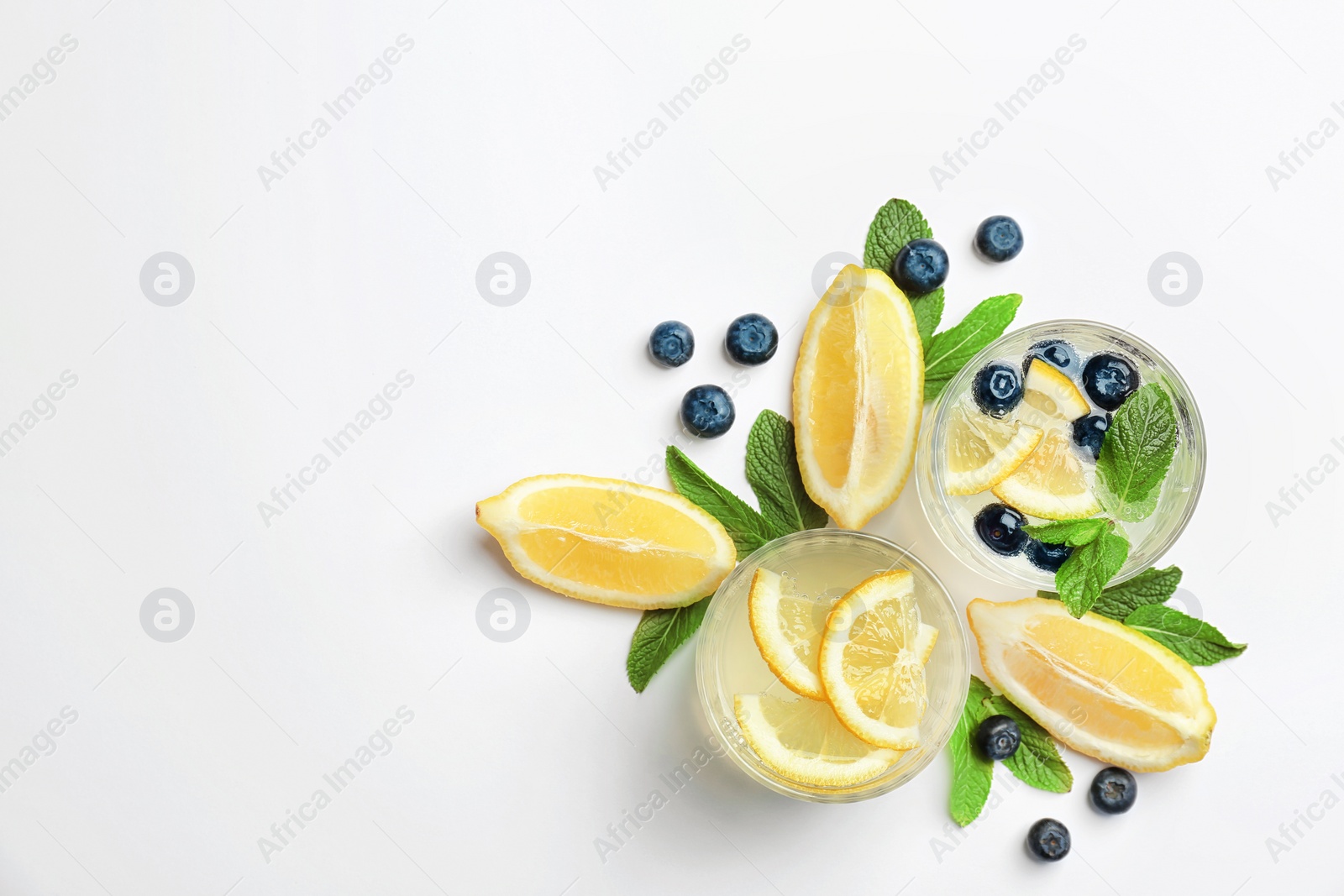 Photo of Flat lay composition with delicious natural lemonade on white background