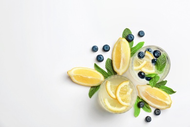 Photo of Flat lay composition with delicious natural lemonade on white background