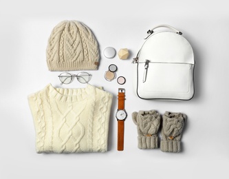 Photo of Stylish female autumn outfit and accessories on white background, flat lay. Trendy warm clothes