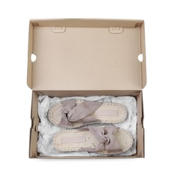 Pair of stylish shoes in cardboard box on white background, top view