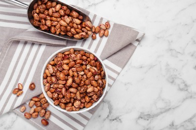 Many dry kidney beans on white marble table, flat lay. Space for text