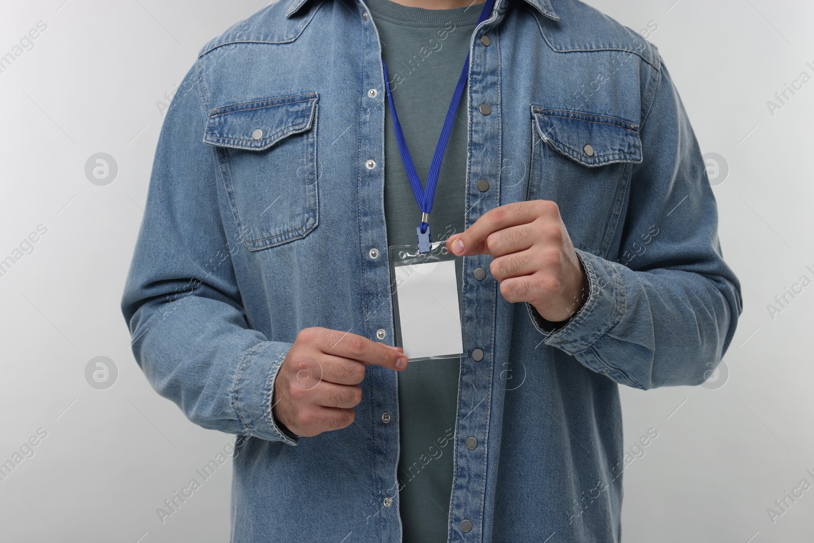 Photo of Man with blank badge on grey background, closeup