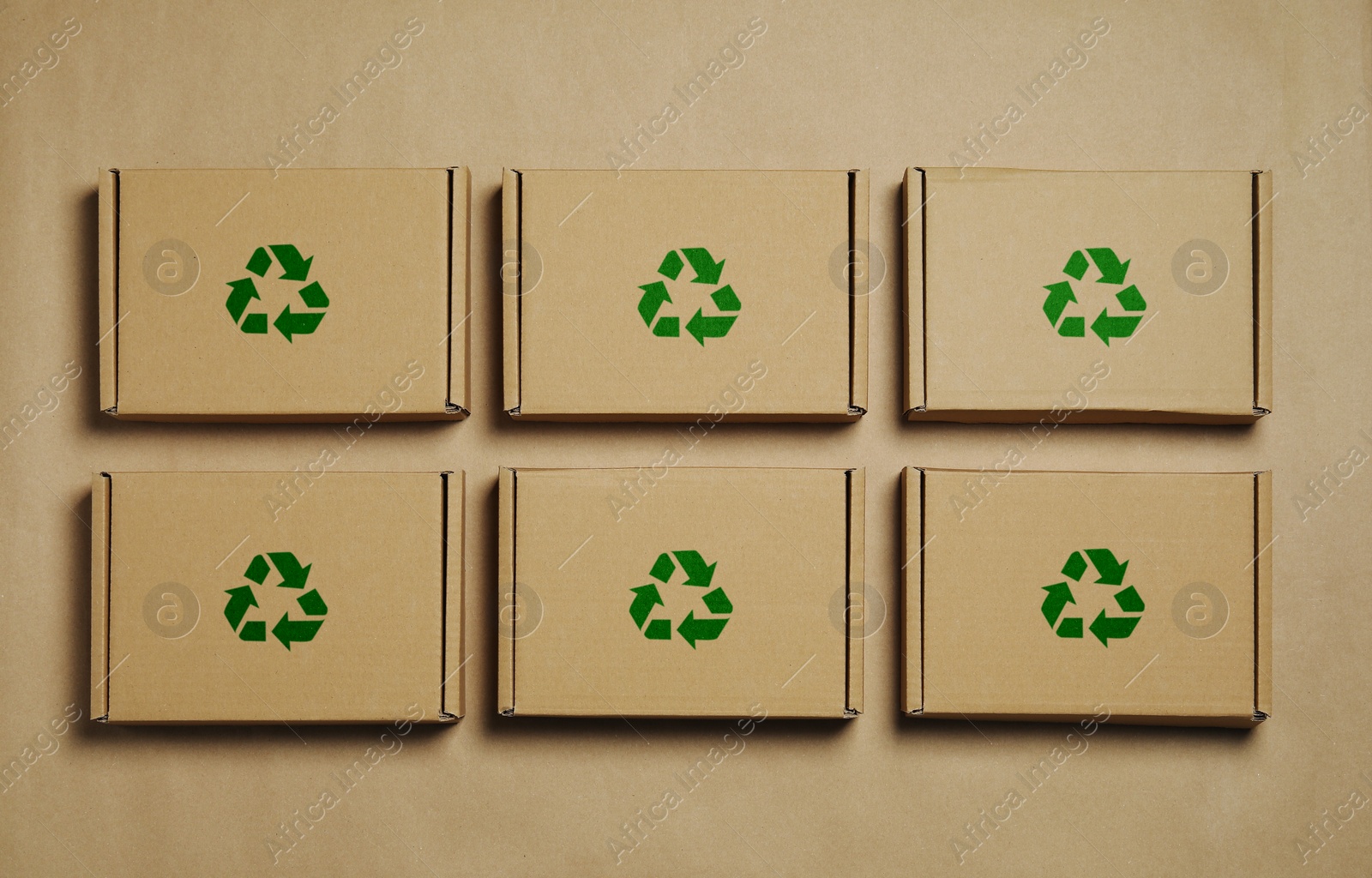 Image of Cardboard boxes with recycle sign stamps on paper, flat lay