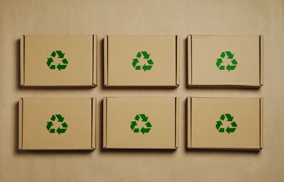 Image of Cardboard boxes with recycle sign stamps on paper, flat lay