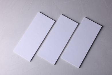 Photo of Blank business cards on light grey textured background, top view. Mockup for design