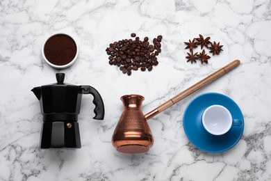 Photo of Flat lay composition with geyser coffee maker and roasted beans on white marble table